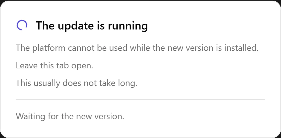 The screen that covers the page during an update, with a spinning circle next to the heading The update is running, then the sentence The platform cannot be used while the new version is installed, the sentence Leave this tab open, the sentence This usually does not take long, a dividing line, and under it the sentence Waiting for the new version. There is no close button and no other button on it.